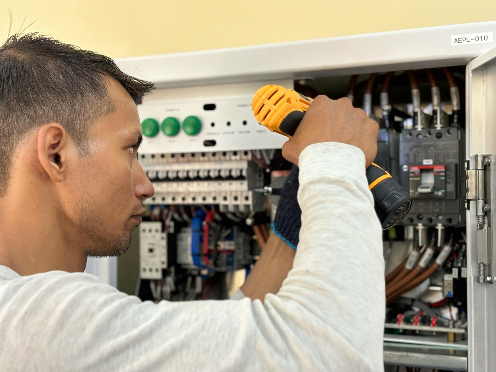 Electrician working on an electrical service panel